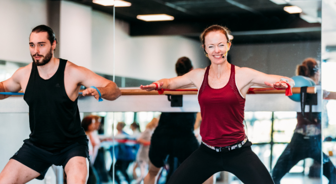 Fitness Instructor smiling while teaching Barre class