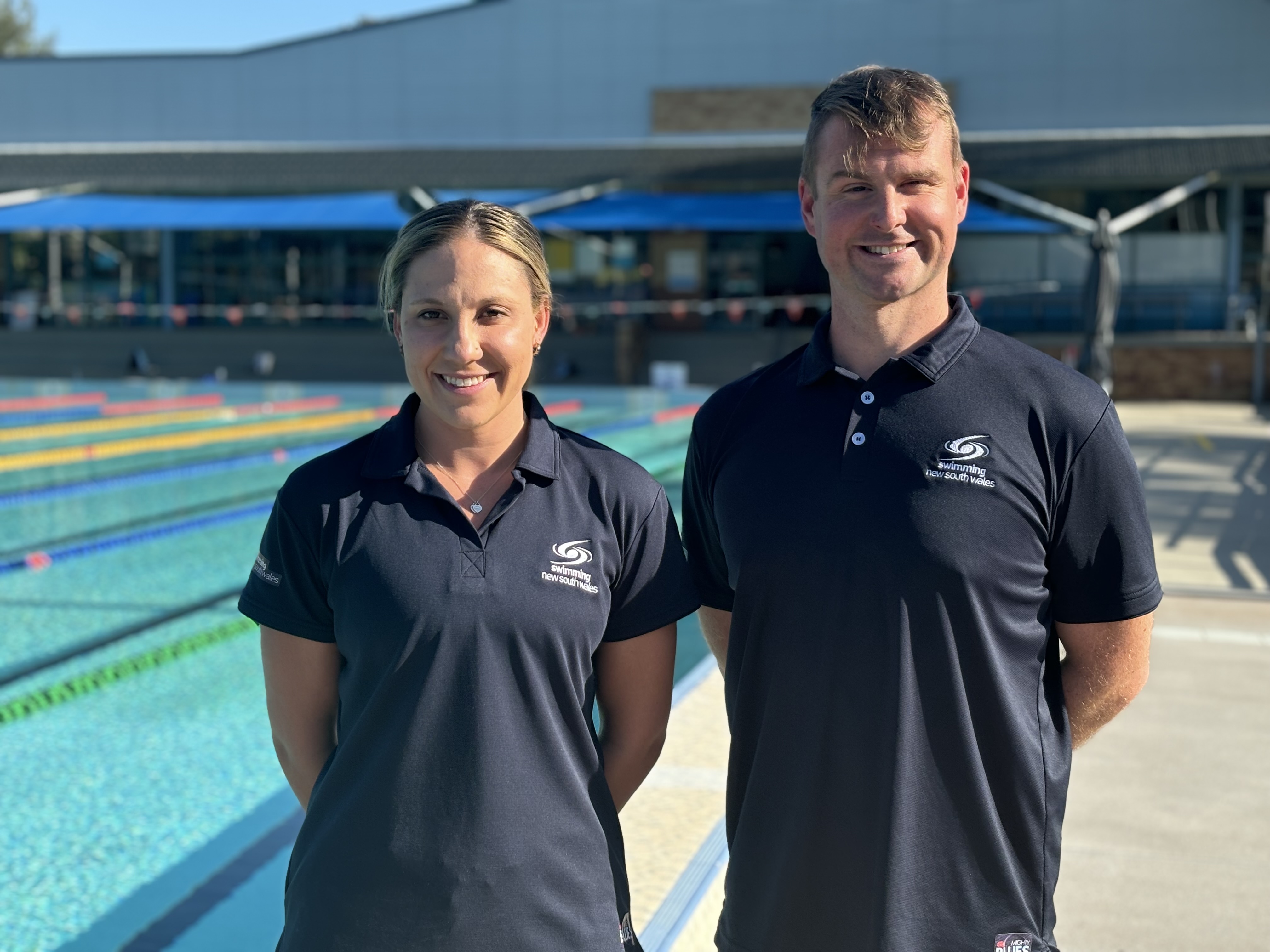 Coaches standing in front of the pool